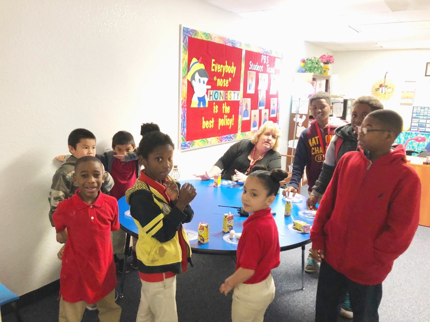 Students having donuts with the Principal as a reward for positive behavior