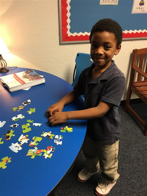 Student putting together a puzzle during Puzzle Time
