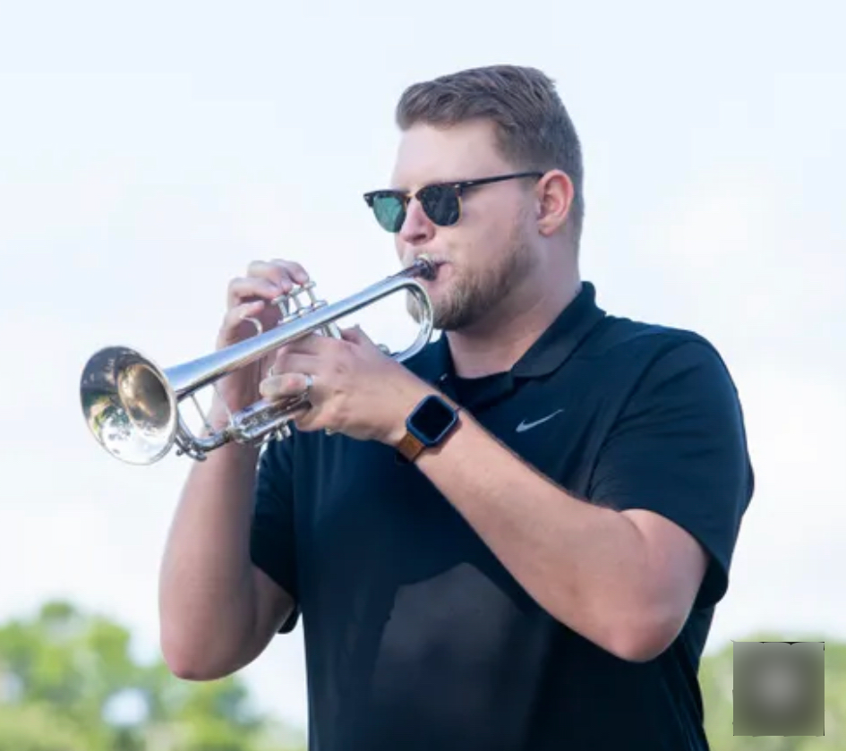 Mr. Campbell playing a trumpet
