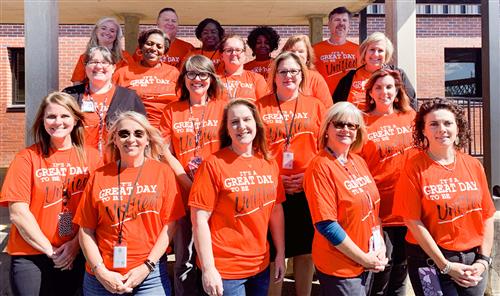 ESE staff in orange Special Olympics shirts reading "It's a great day to be unified"